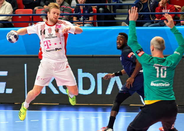 A group of men playing handball on a court during a match labeled "Futsal World Cup 2019 - Bayern Munich vs Paris Saint-Germain" in a stadium setting.