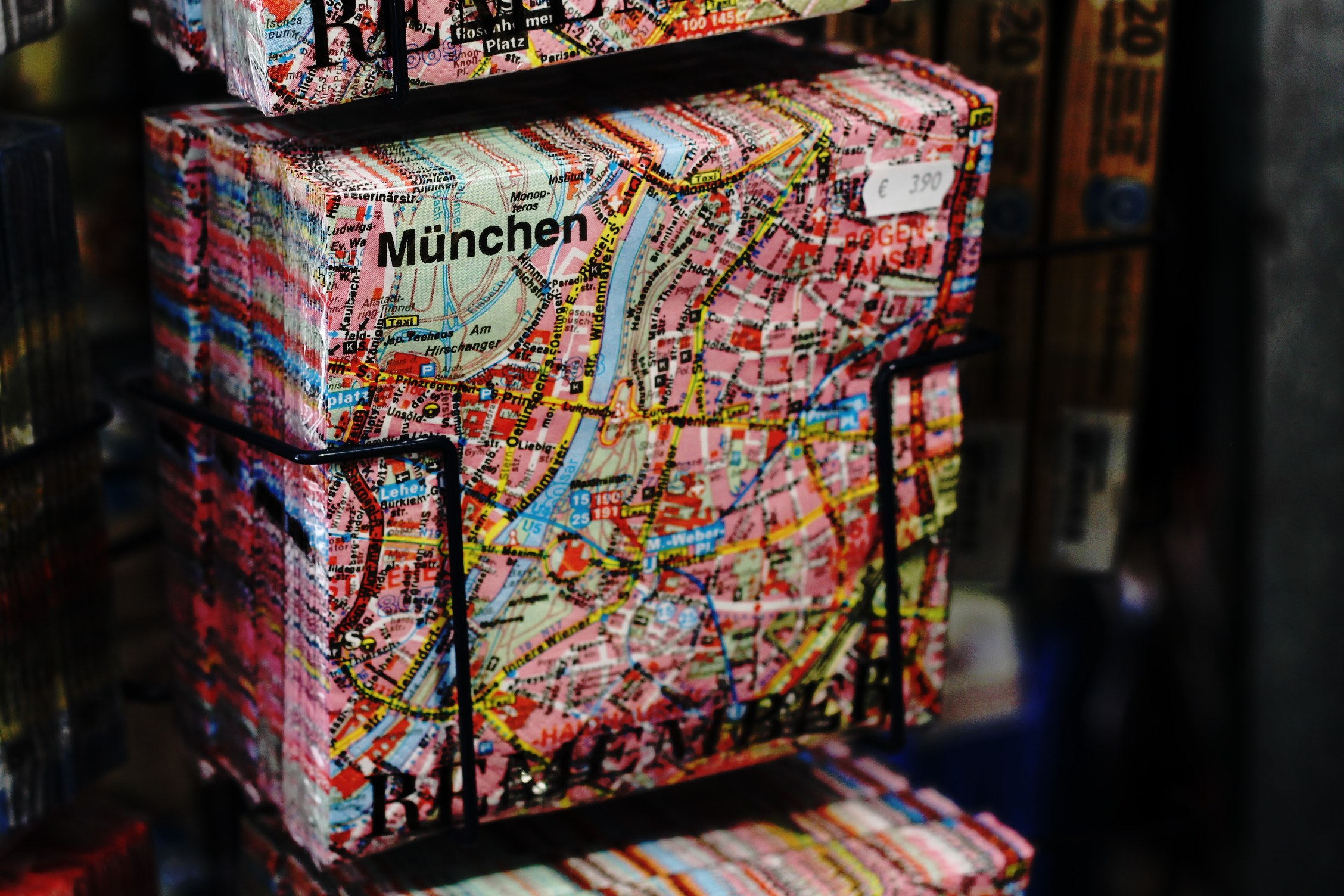 Open book with a detailed map of Berlin, Germany, featuring a cityscape surrounded by trees and buildings under a cloudy sky.