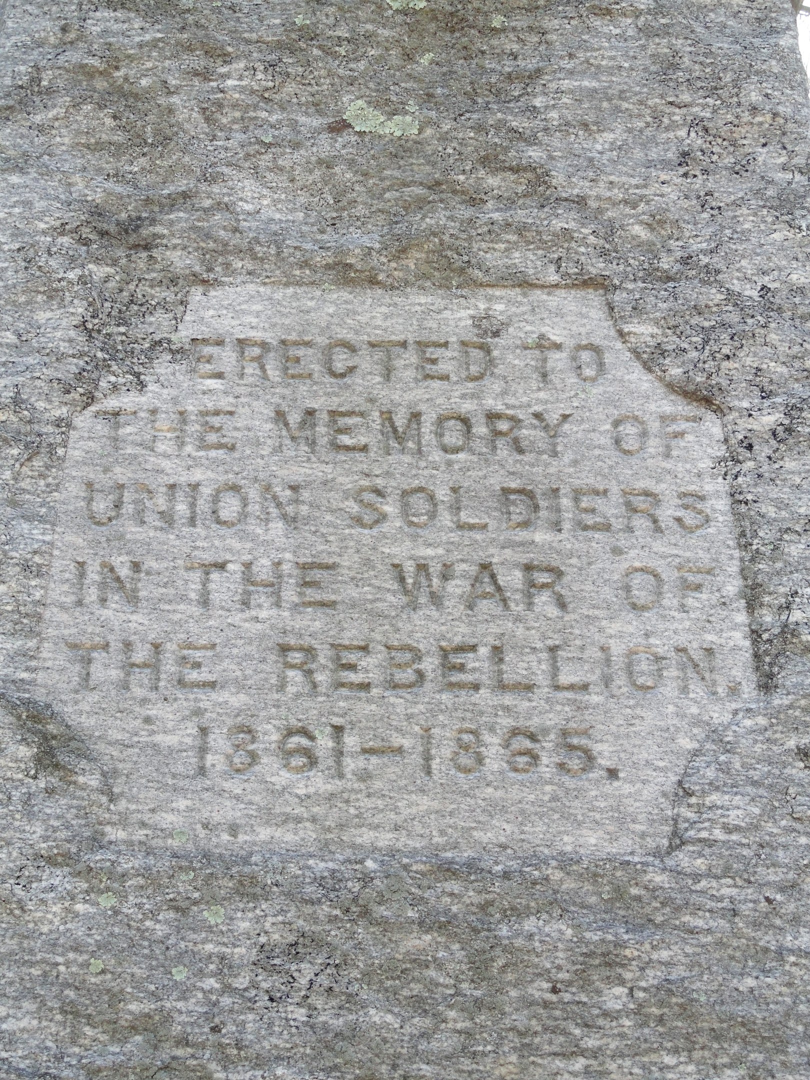 Stone plaque inscribed "The Memory of Union Soldiers in the War of the Rebellion" mounted on a stone, commemorating soldiers of the Civil War.