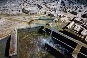 Ein Miniaturstadtmodell mit einem zentralen Springbrunnen mit Wasserfall, umgeben von Gebäuden und Wasserfeatures.